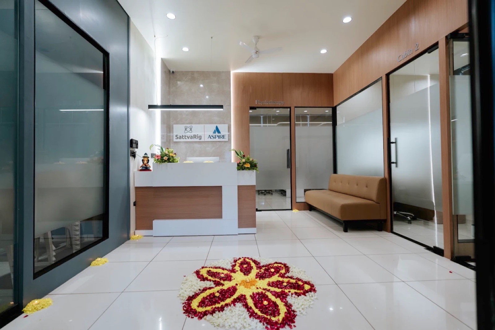 The SattvaRig reception decorated with a flower rangoli, welcoming patients on their first visit